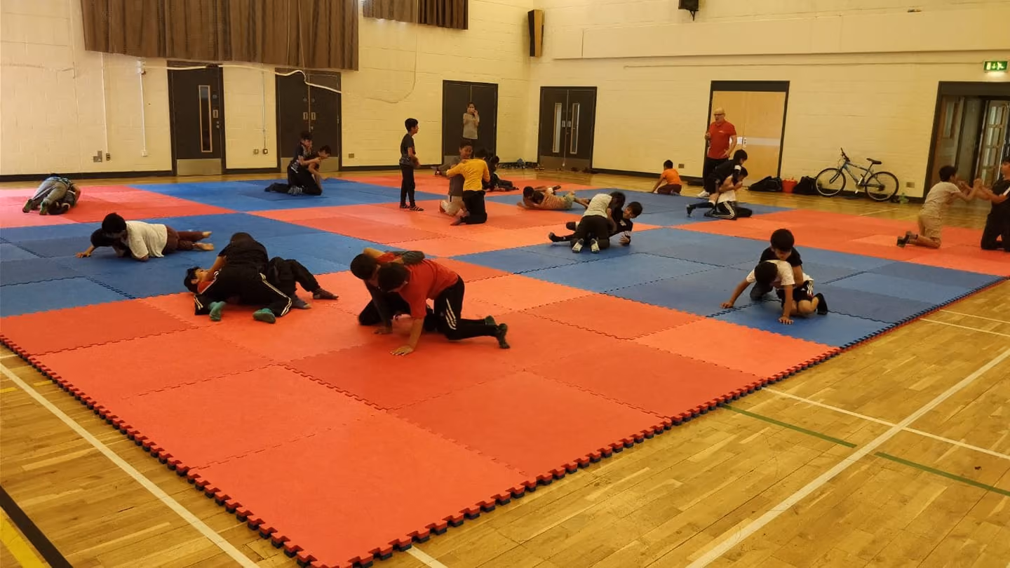 Futuwwa wrestling club members wrestling on a mat