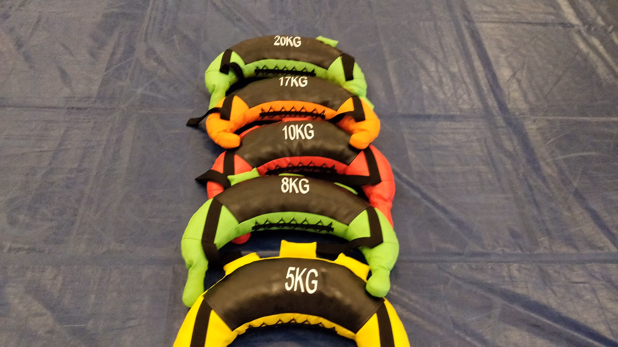 Bulgarian bags laid out on a wrestling mat