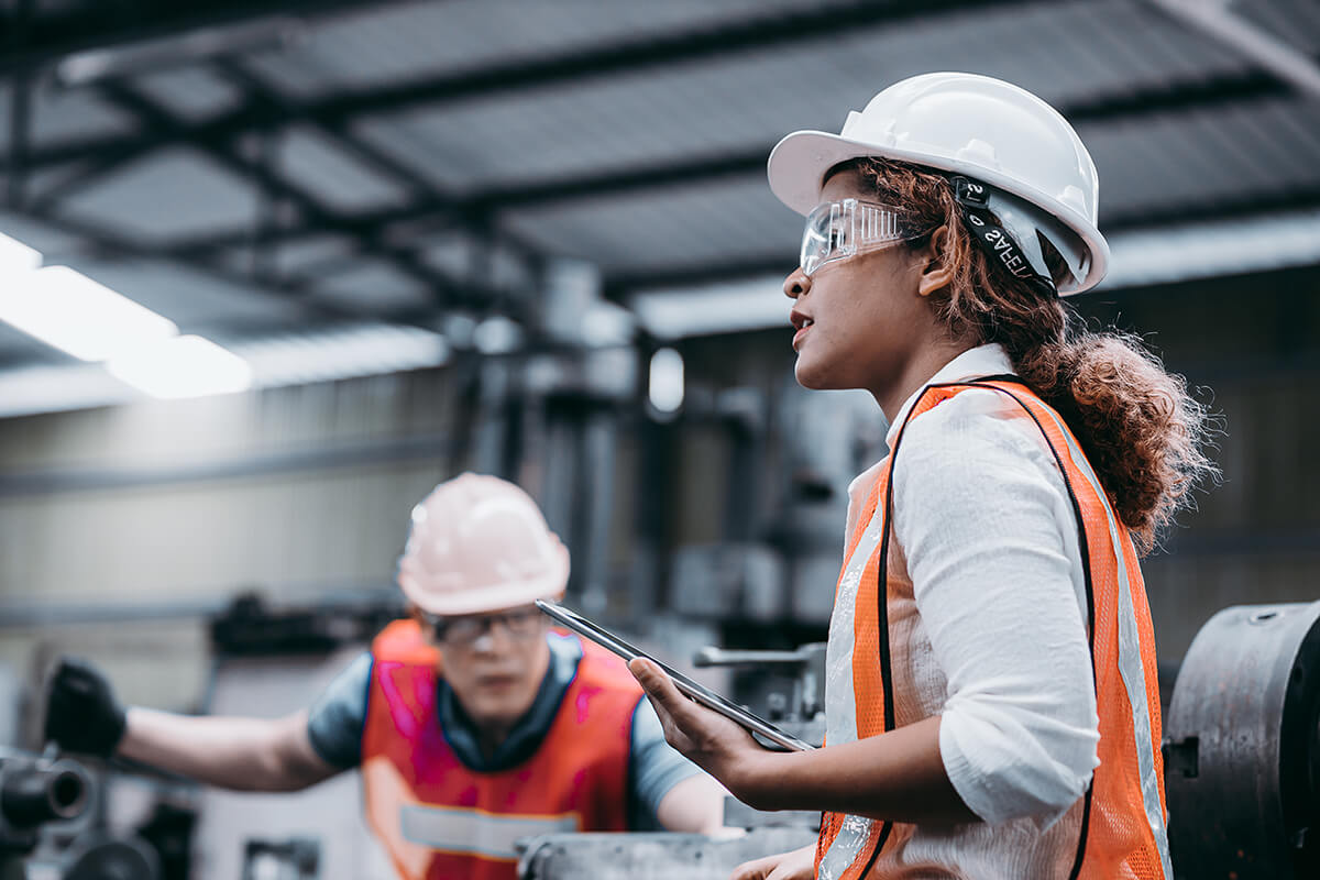 Image of a woman in a worksite with a tablet.
