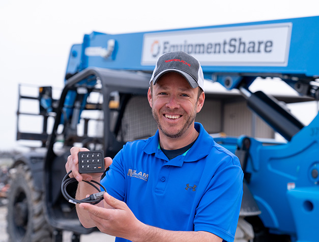 Construction worker holding T3 keypad.
