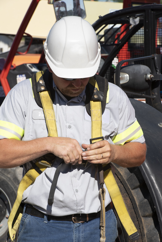 man putting on safety equipment