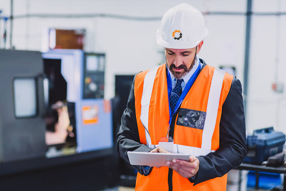 man working on iPad.