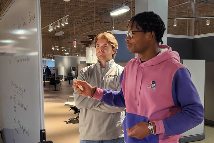 men using a whiteboard.