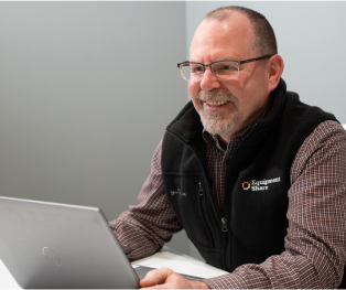 Man in office working on Laptop.