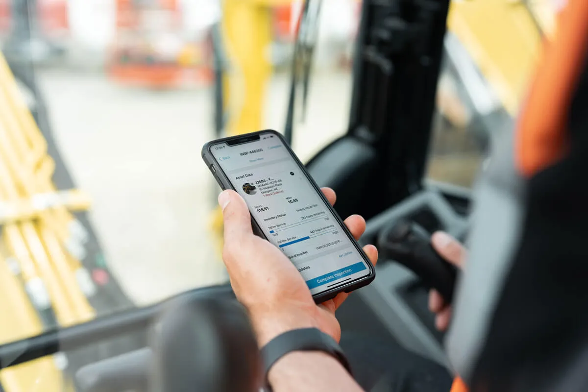 Phone in hand showing T3 Tracking app.