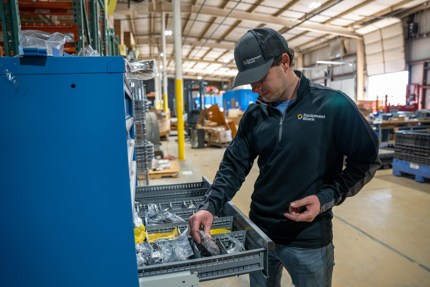 EquipmentShaer employee getting parts in a warehouse.