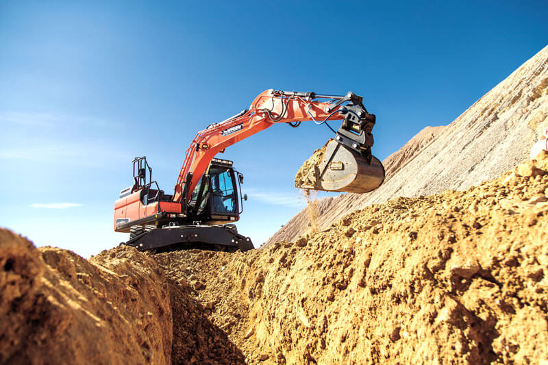 tracked excavator digging excavating ground on jobsite