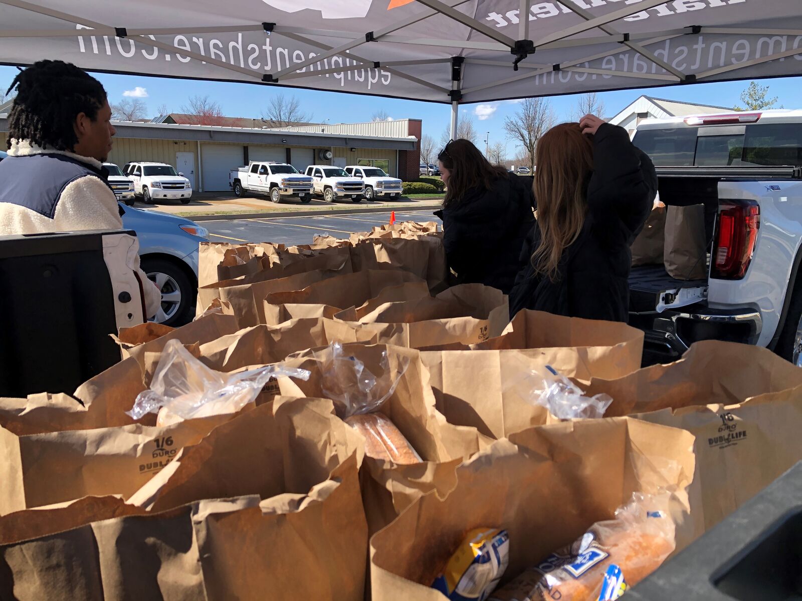 employees and educators prepare for the food pickup line