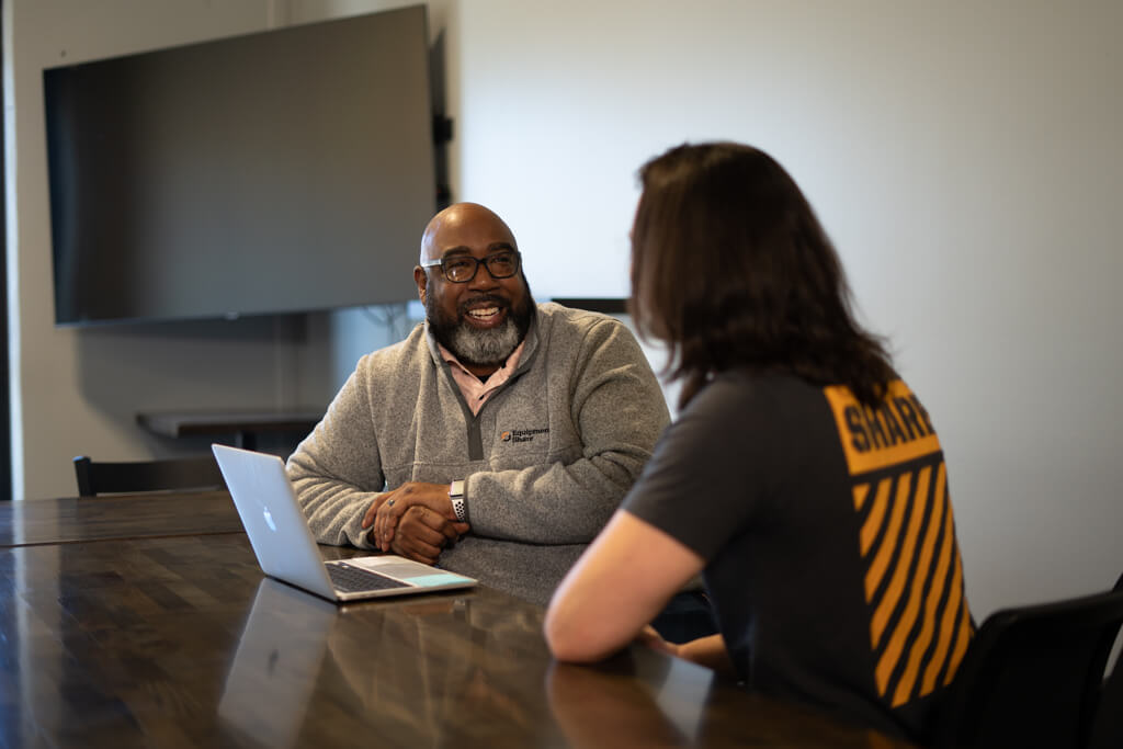 two men meeting and discussing in a conference room.