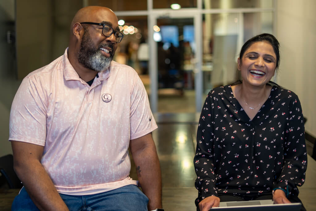 A man a woman laughing and having a good time.