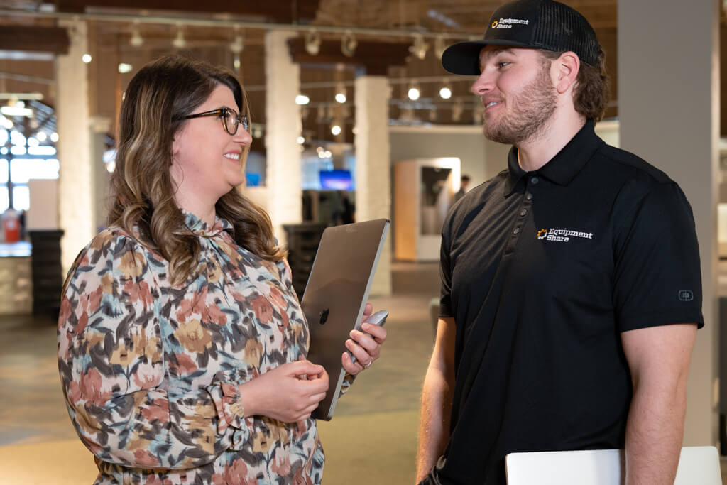Two EquipmentShare employees laughing.