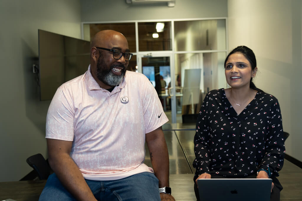 Two EquipmentShare employees laughing.