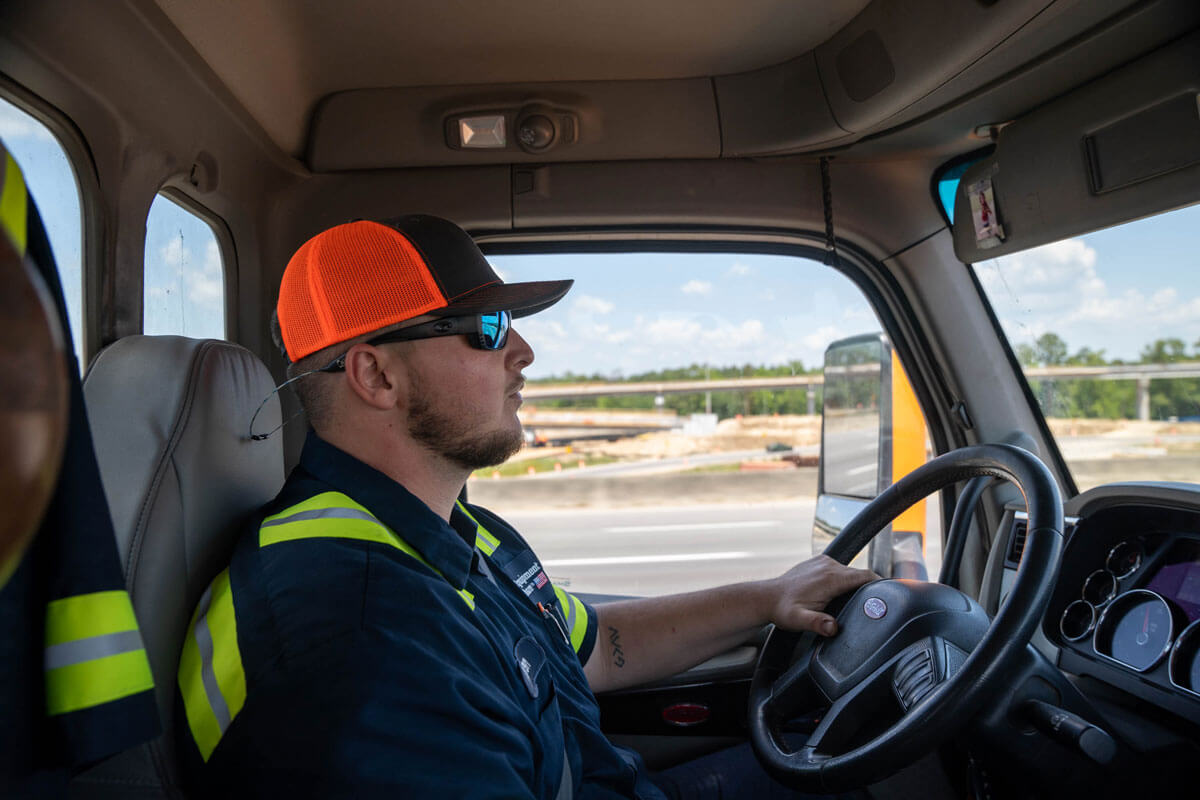 Man driving a truck down a highway