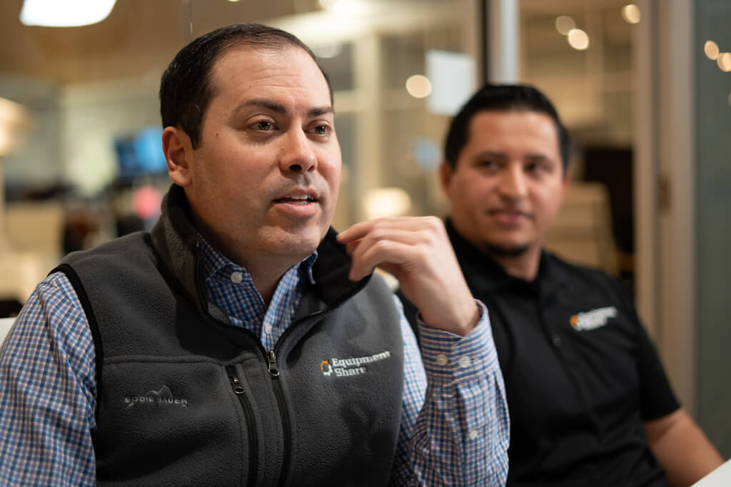 Two men in a meeting talking.