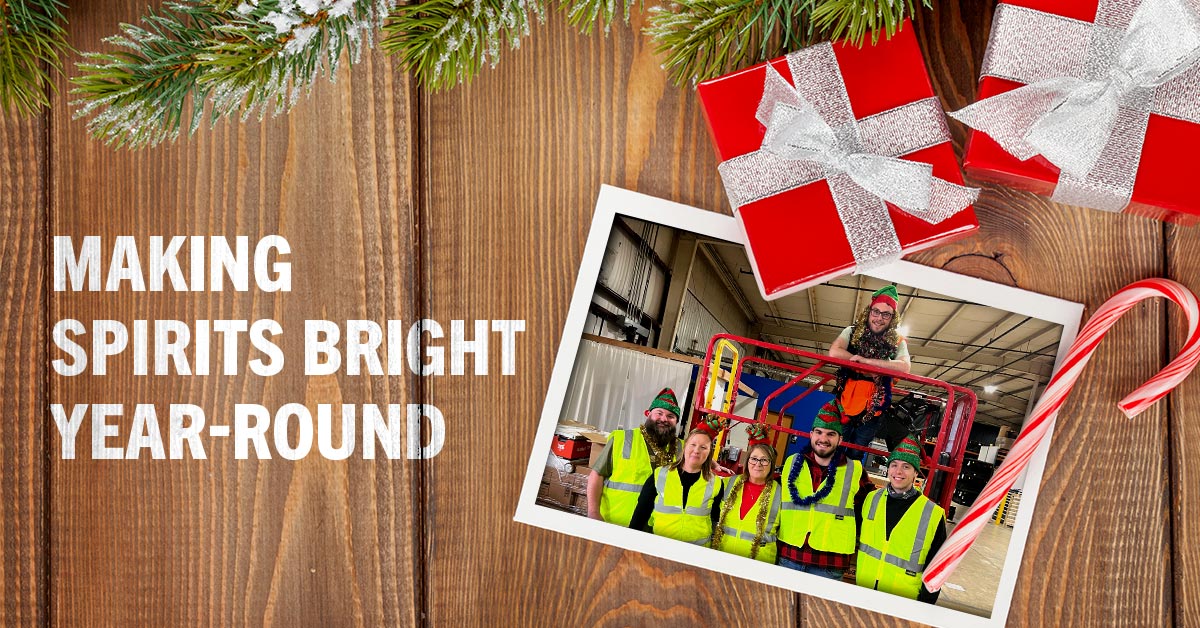 Warehouse elves gather for a photo with a forklift