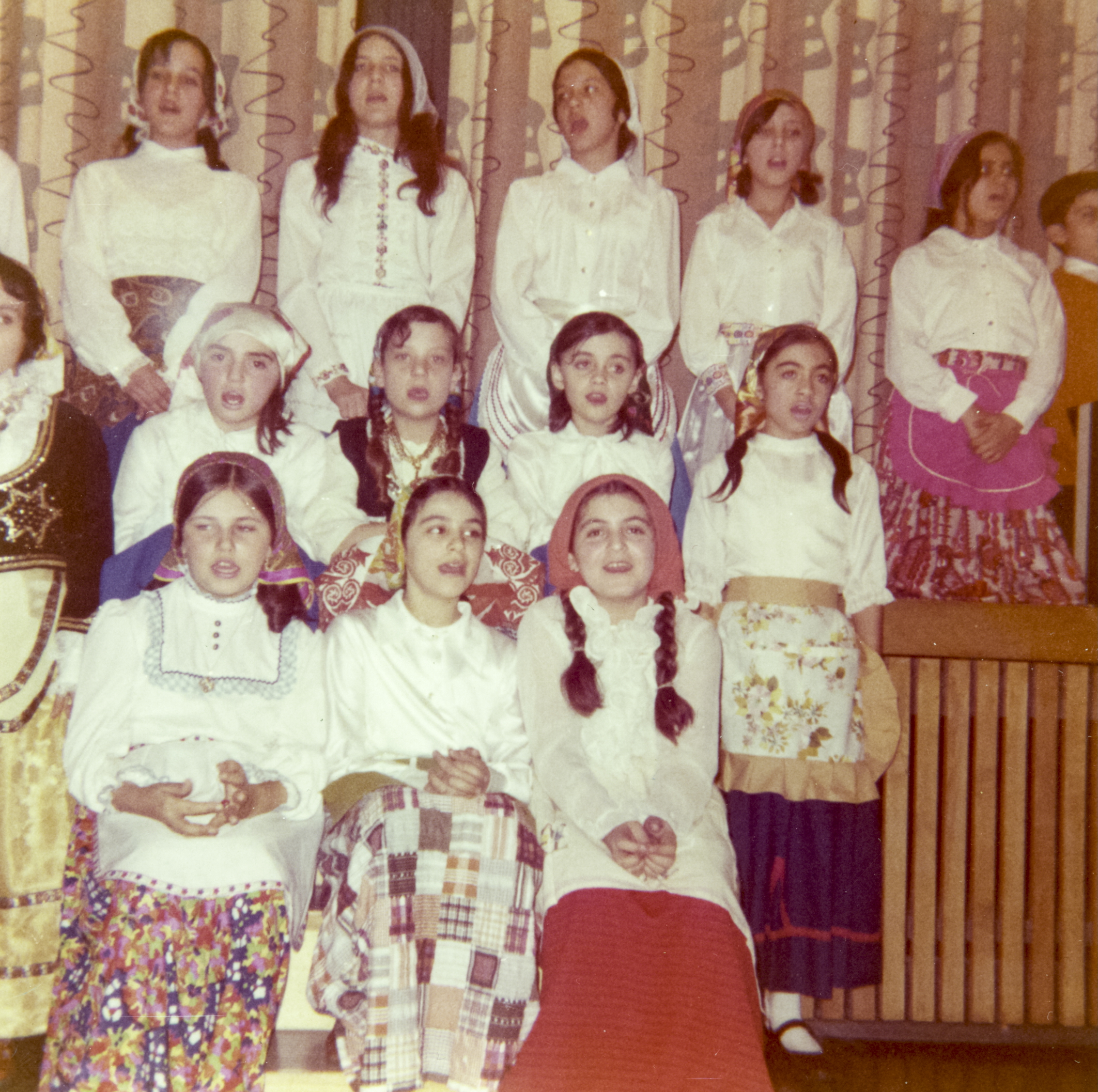 Helen (wearing pink in the far right of the frame) in a Greek school play, early 1970s