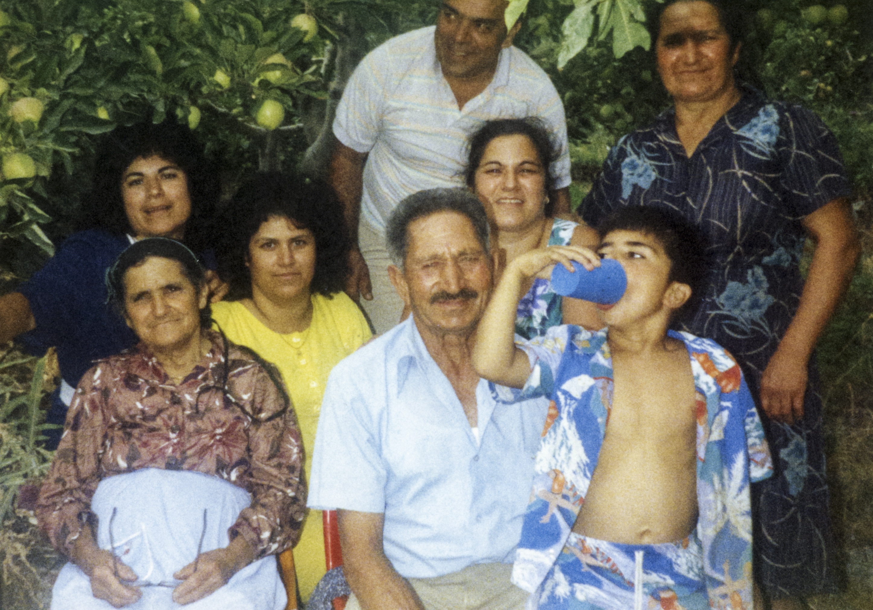 Helen's mother (in the centre of the middle row) with her parents, sisters,  one of her brothers, and son, late 1980s