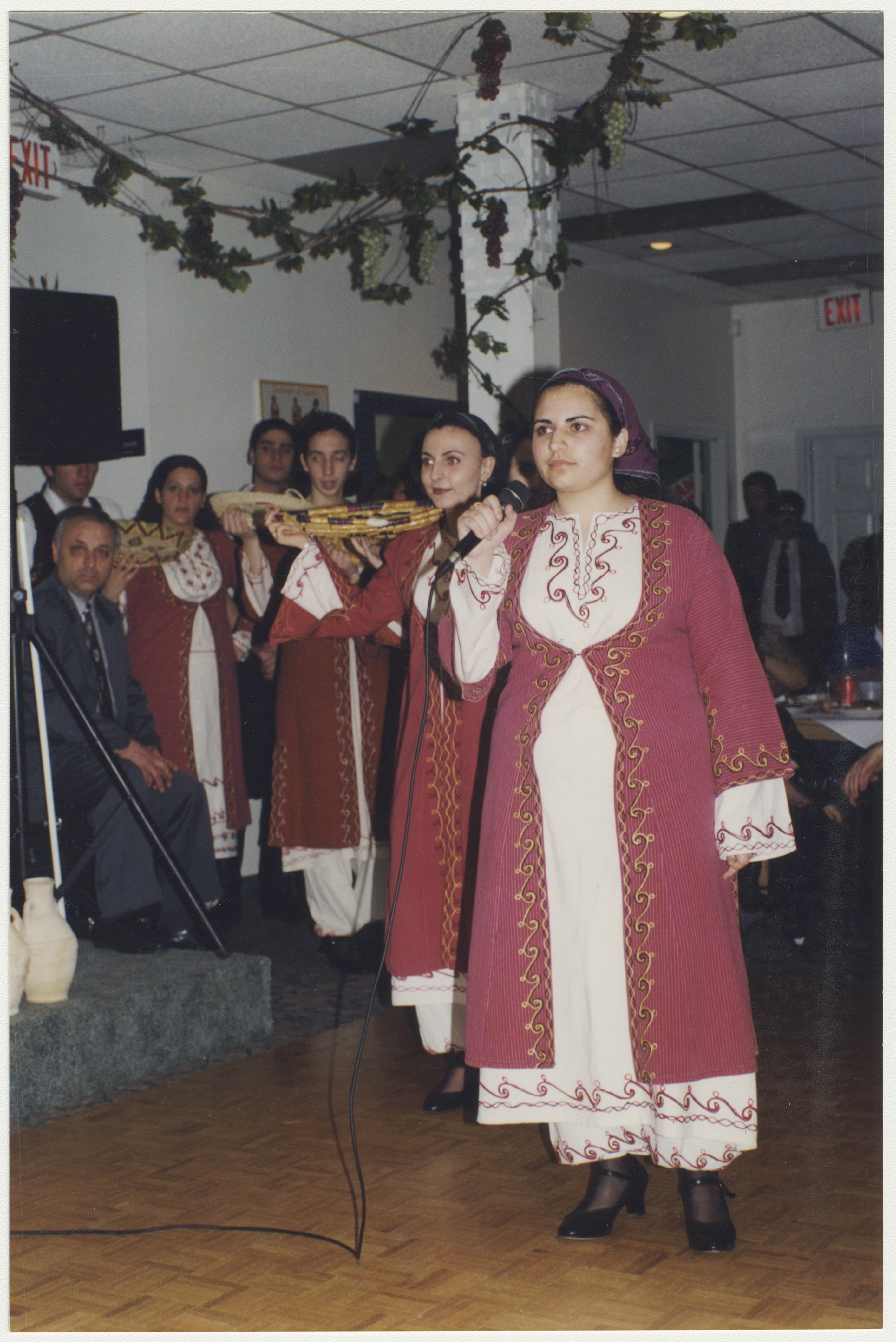 Helen's sister (with the microphone) in the Cypriot dance group, late 1990s. York University Libraries, ASC61632