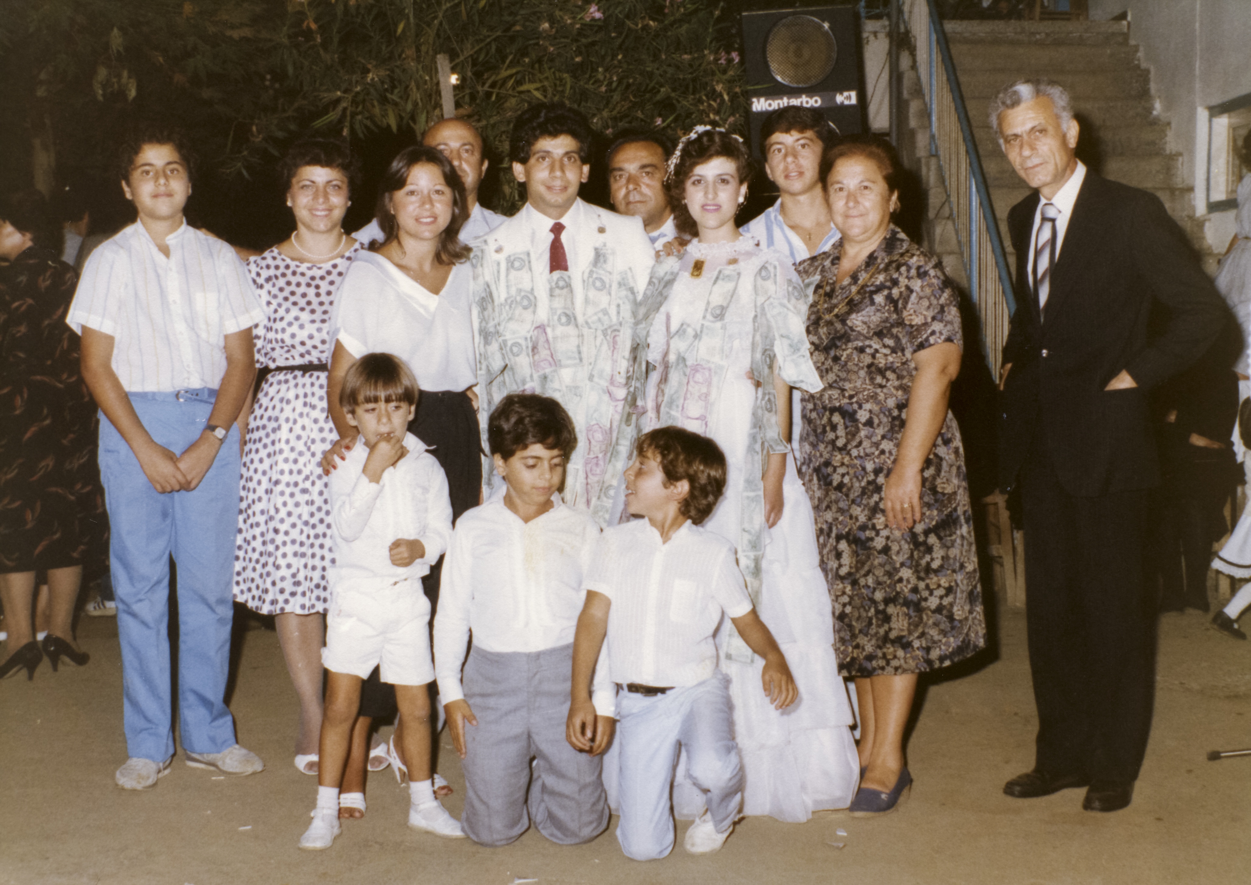 George (obscured in the back row) with his wife's family at a wedding in Kambos, early 1980s 