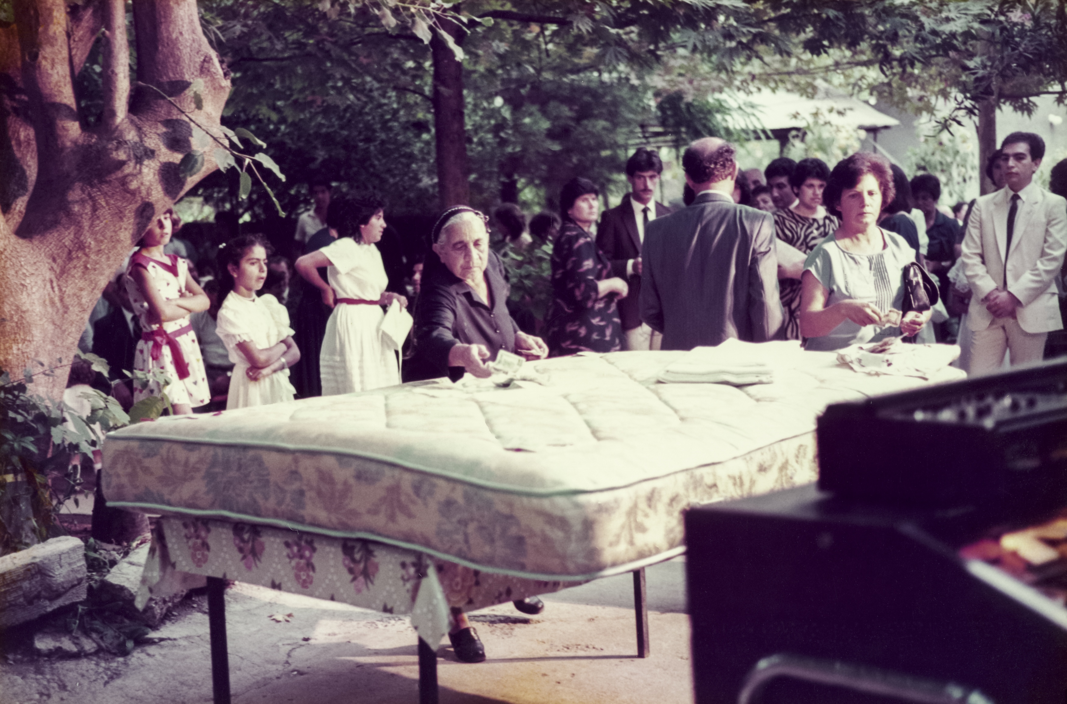 Nitsa's yiayia putting money on the bed at a wedding in Kambos, early 1980s