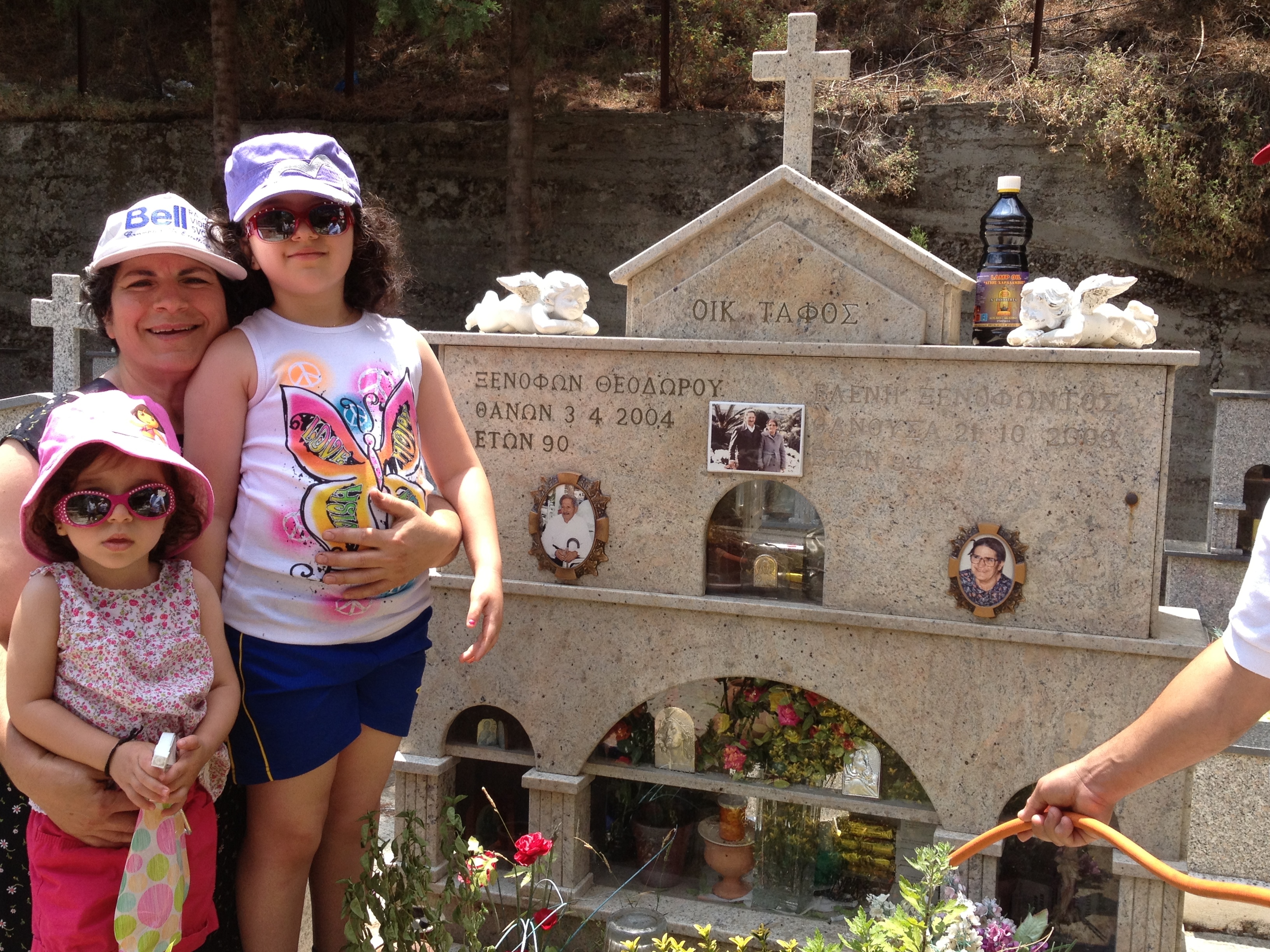 Anna's daughters with their yiayia visiting the grave of their great-grandparents in Kyperounda, 2013