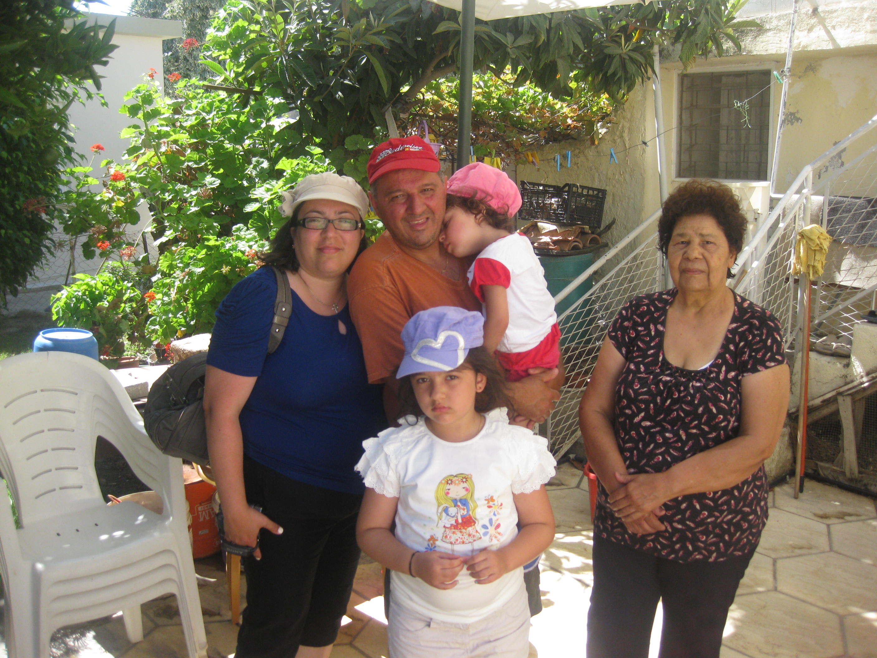 Anna with her family and a settler from Turkey, visiting her husband's old home in Kyrenia that is now occupied by the settler, 2013