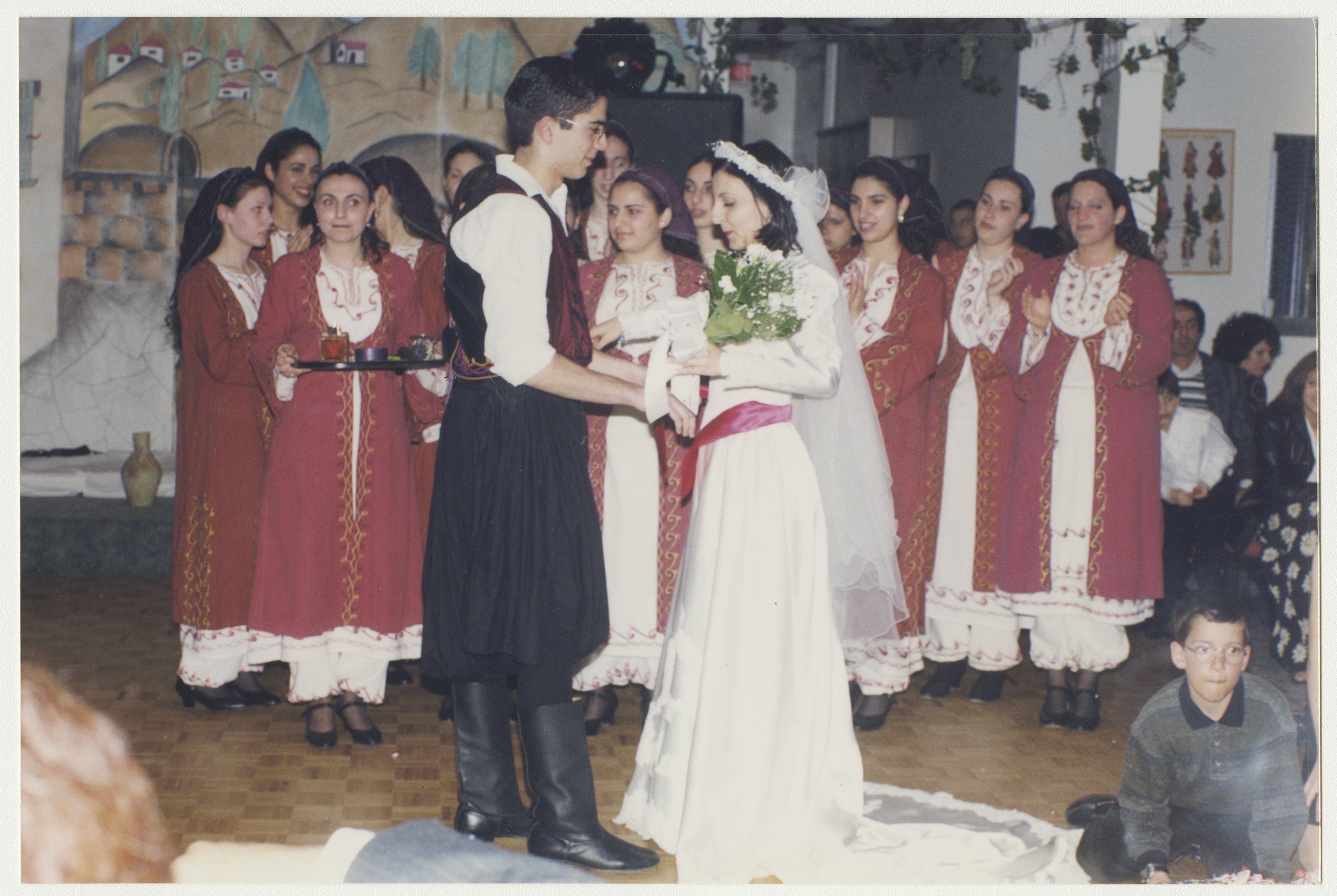 Helen's sister (in the centre of the background) in the Cypriot dance group, late 1990s. York University Libraries, ASC61630