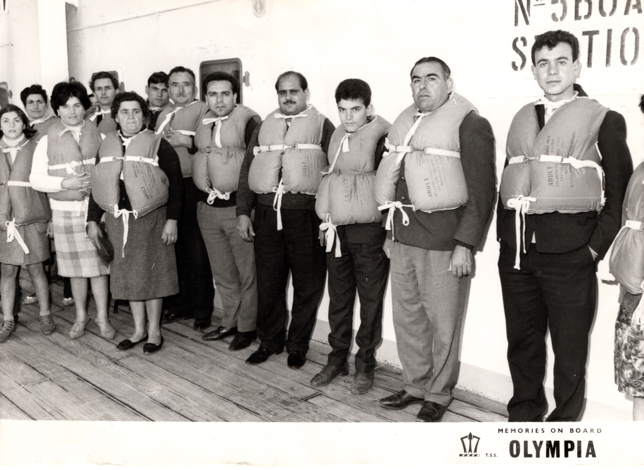 Theodoros (in between two moustached men) with fellow migrants on the way to Canada, 1966