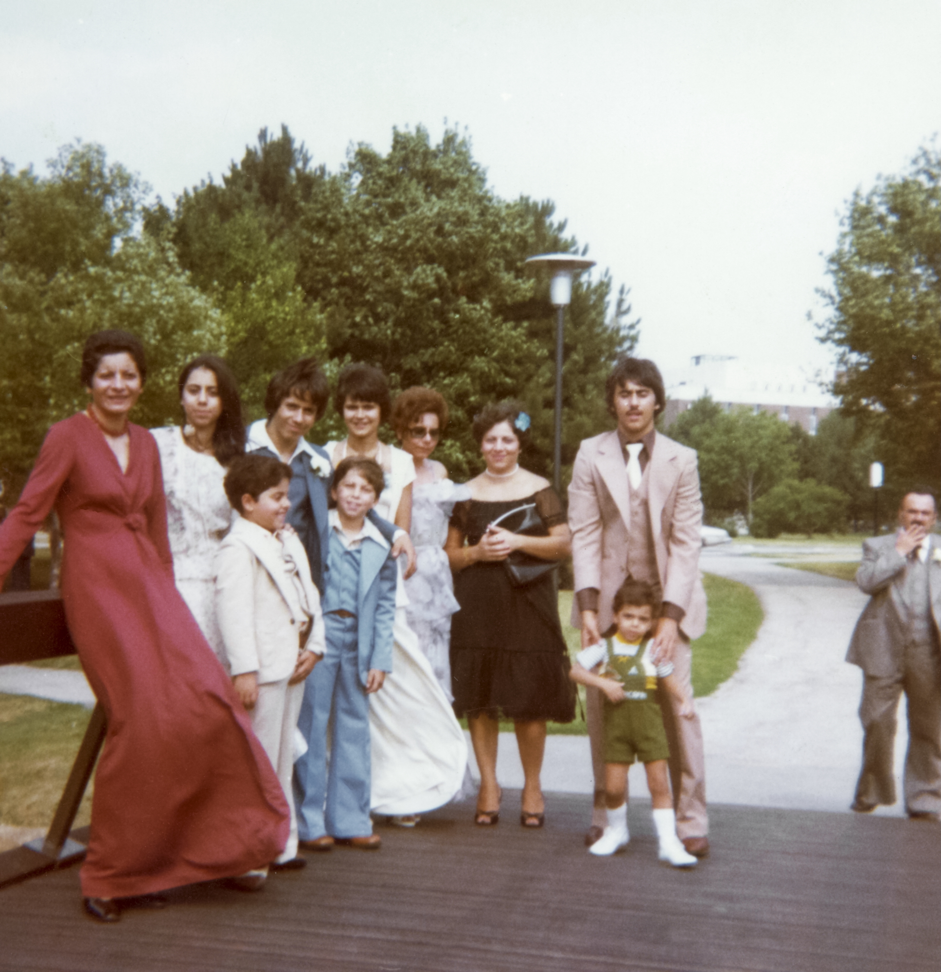 Nitsa's sister and brother (beside their aunt in the red dress) and extended family at a wedding, late 1970s