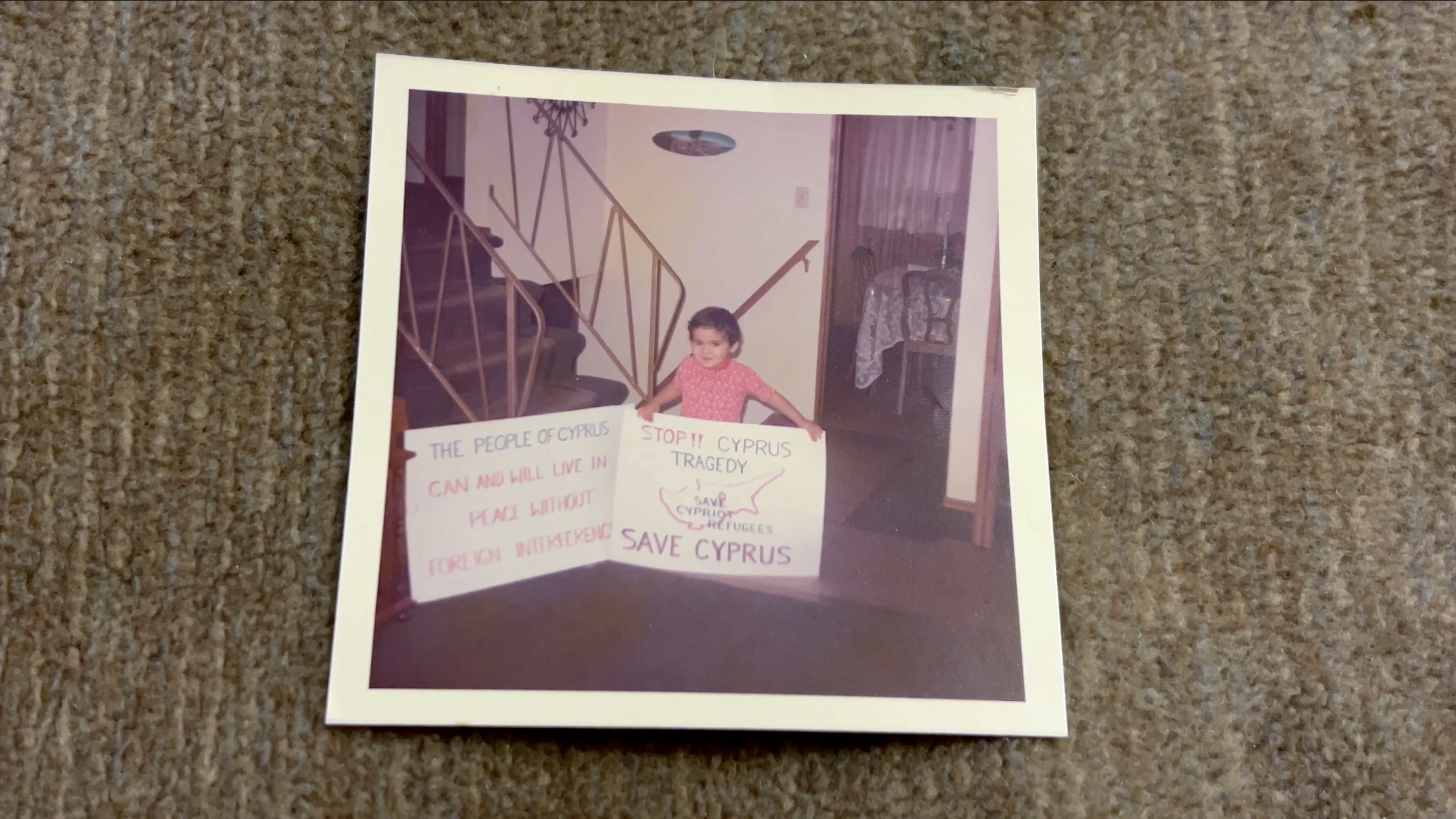 Androula's son with signs made by his parents, getting ready to go to Ottawa to protest the Turkish invasion, 1974 
