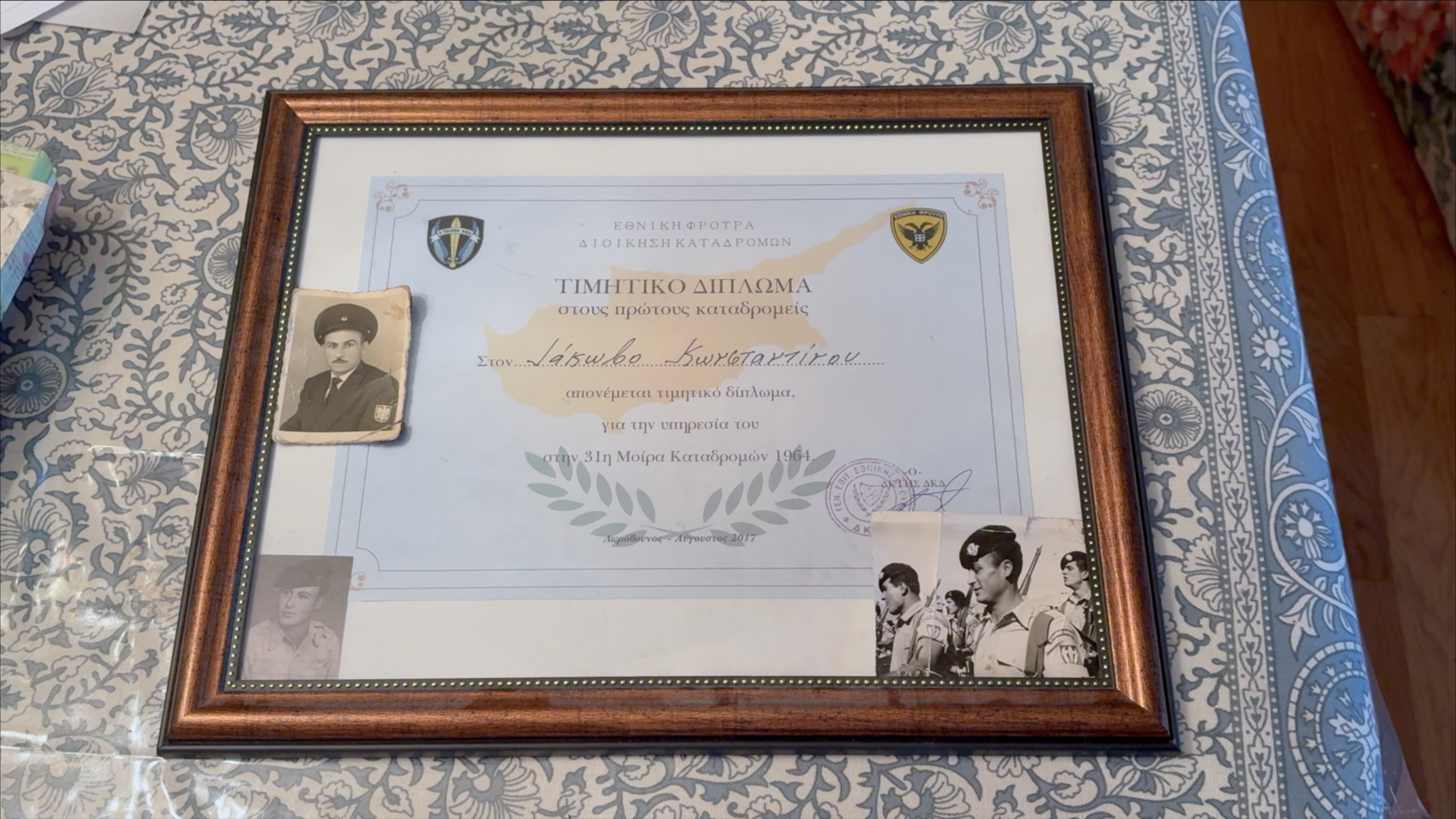 Certificate commemorating Jack’s military service adorned with photos (including one of his father)