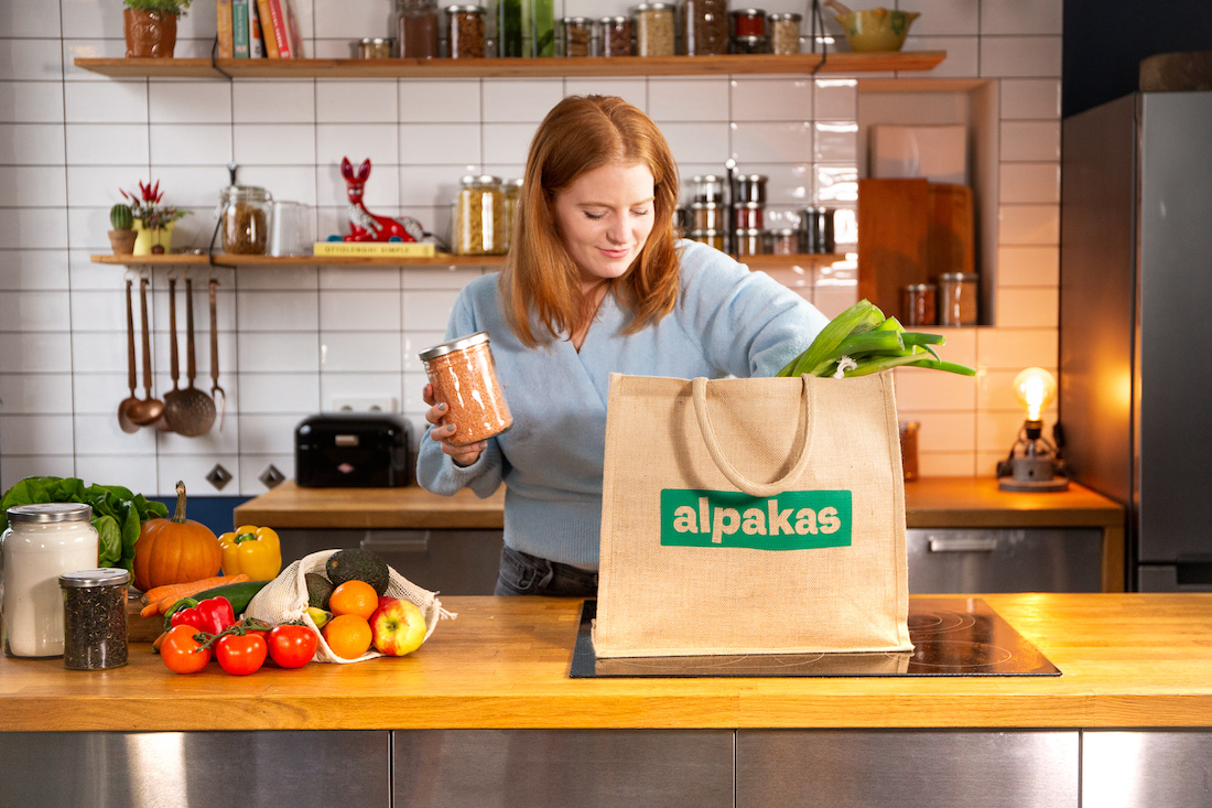 Woman putting groceries inside bag