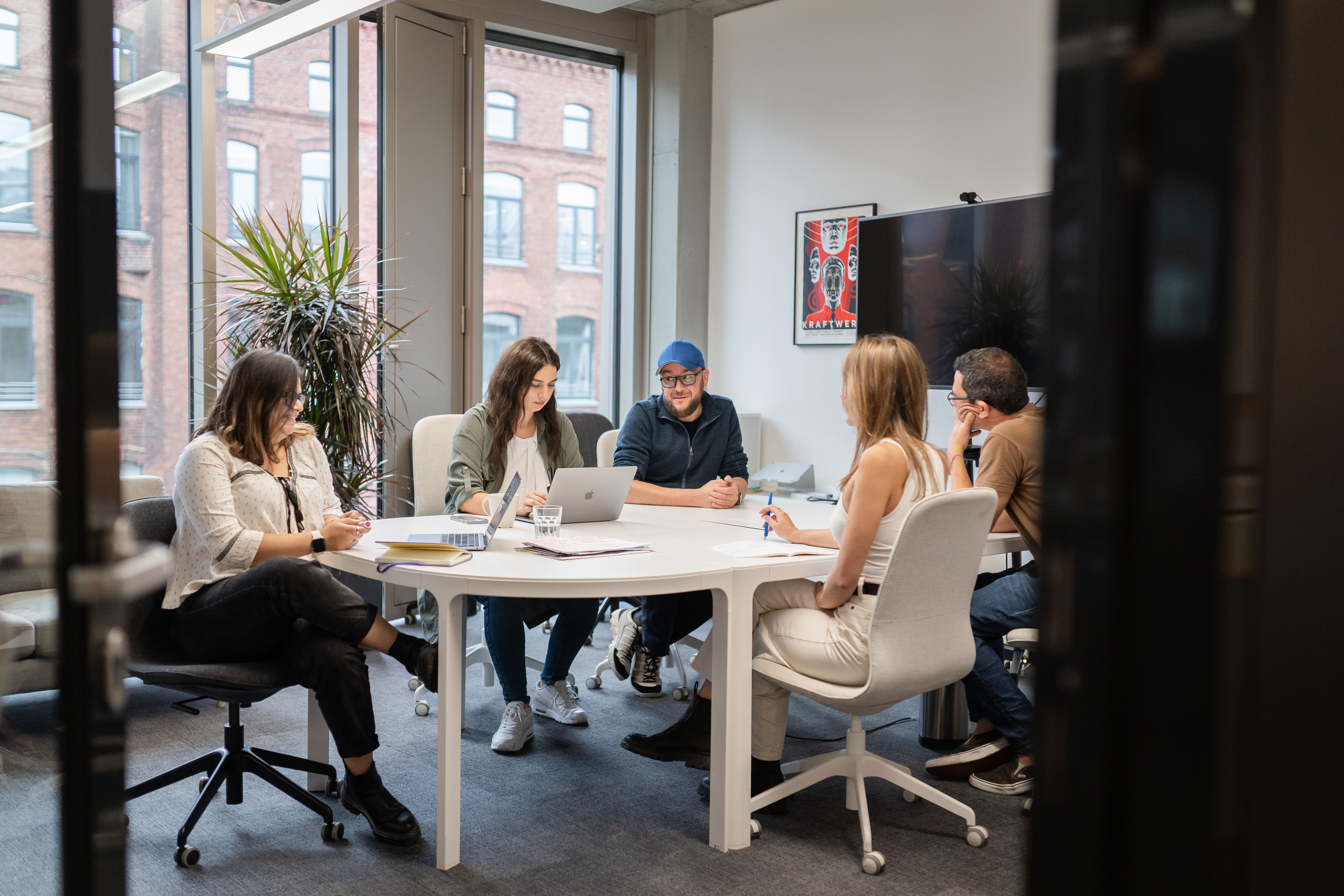 People sitting around desk on a meeting