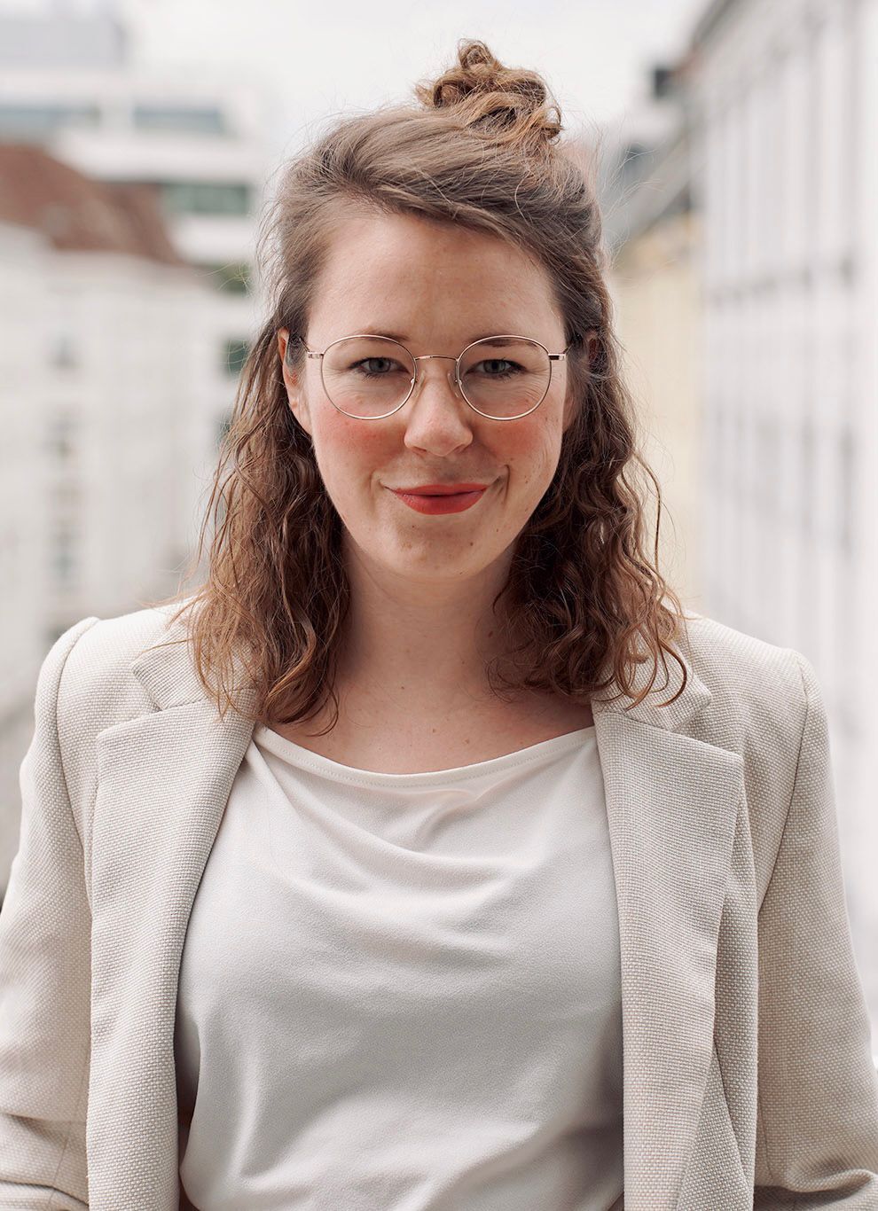 A portrait of a Woman smiling with a blurred background