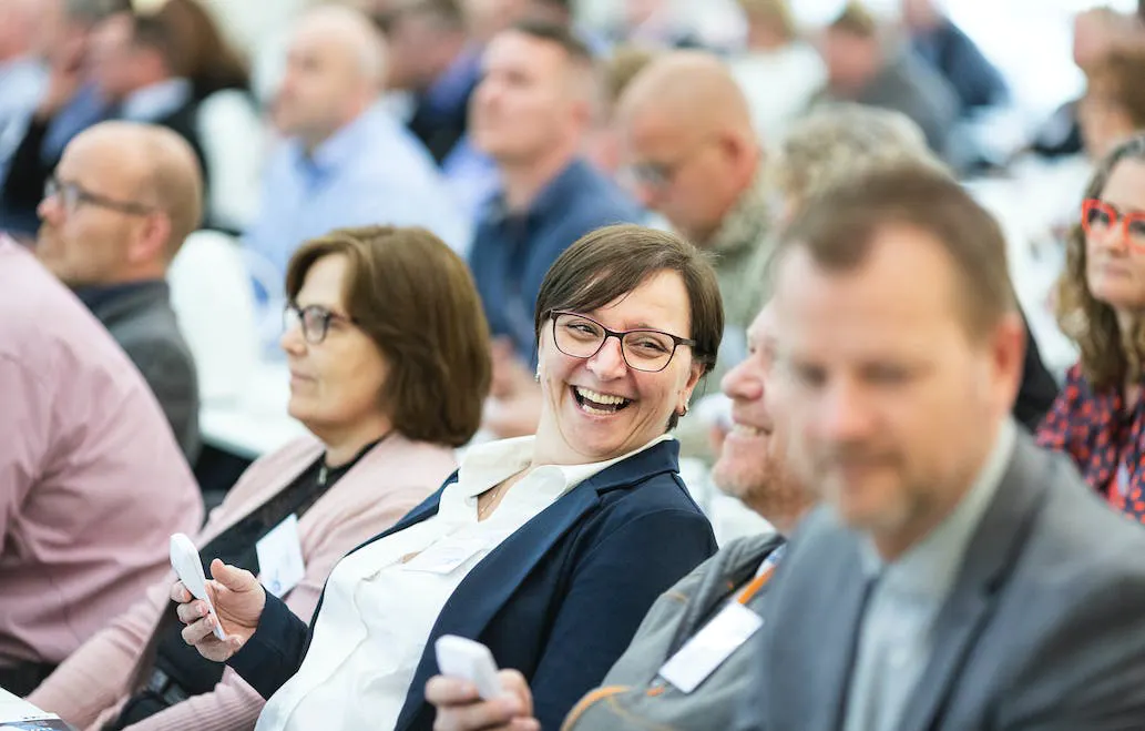 Woman laughing between croud