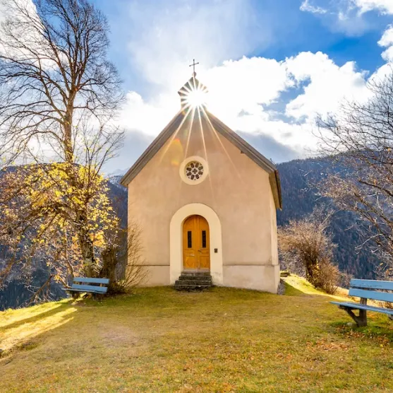 A chapel photographed against the sun