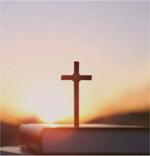 Image of a cross against the sun.