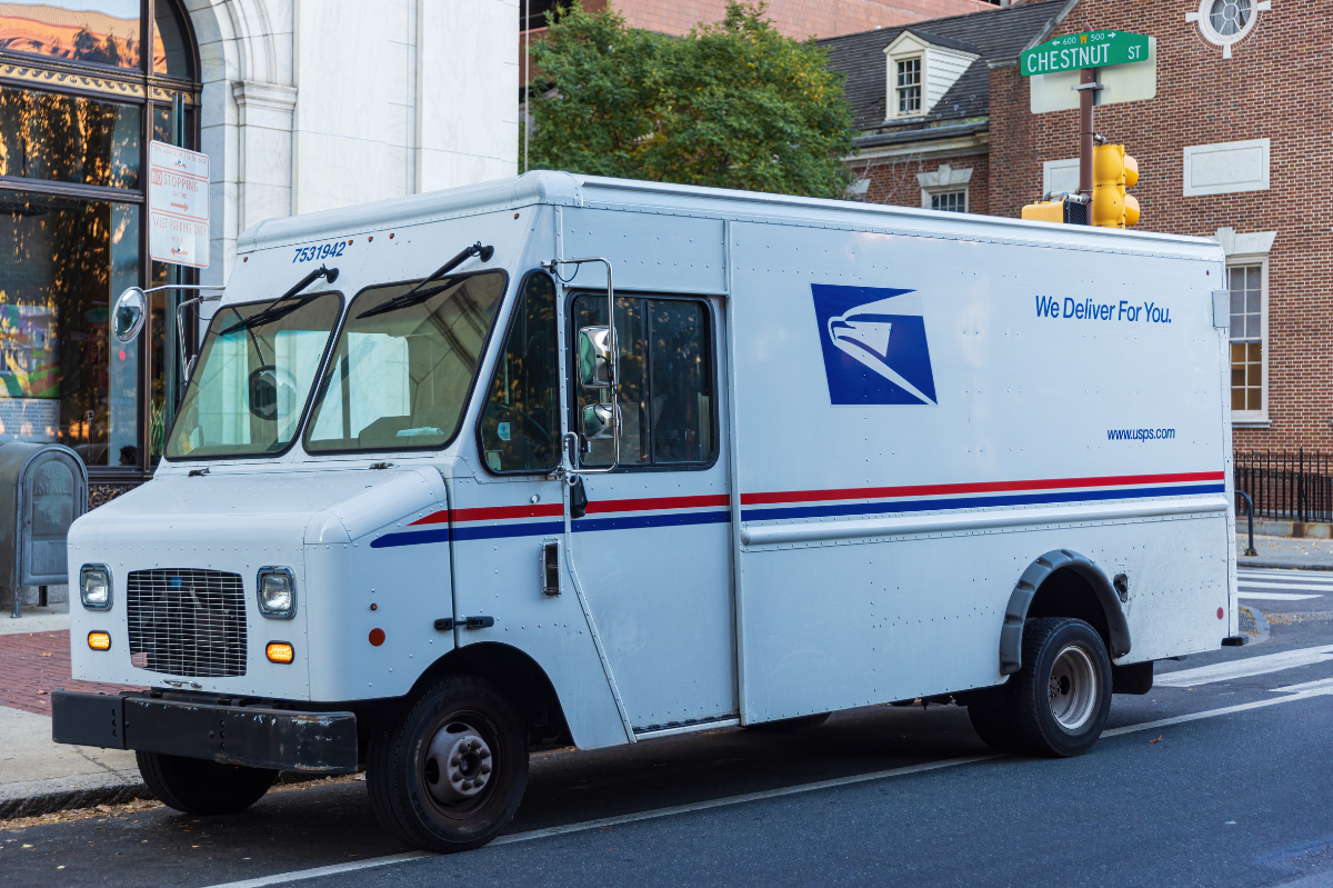 USPS delivery truck parked at the side of the road