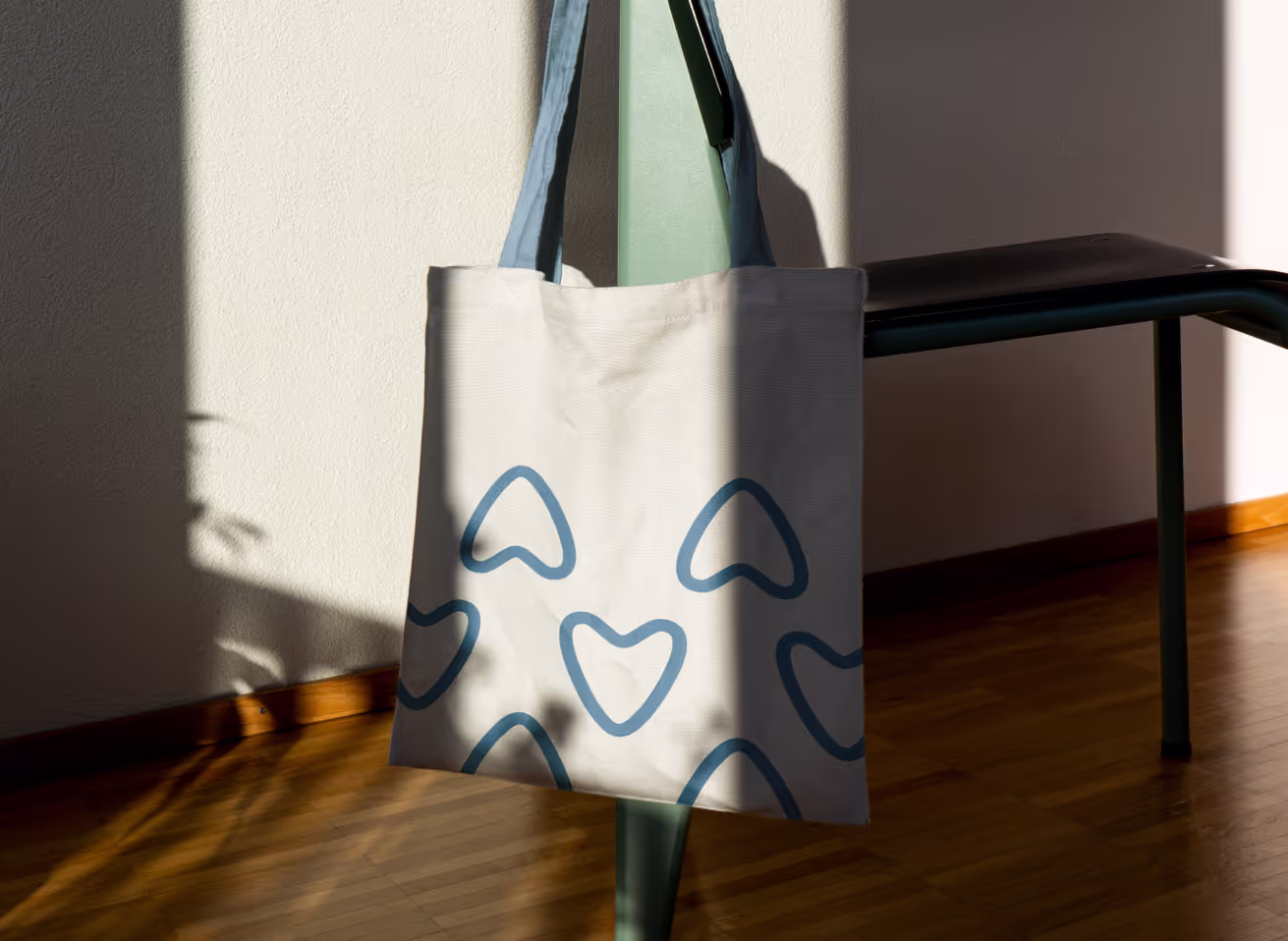 MindCompass logo icon in blue on a white tote bag.
