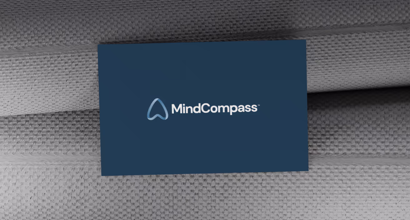 MindCompass logo on a business card.