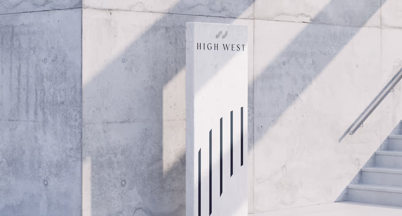 a tall white block advertising for high west, sitting next to a set of stairs