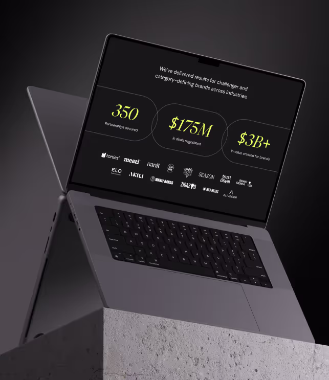 a laptop computer sitting on top of a stone block