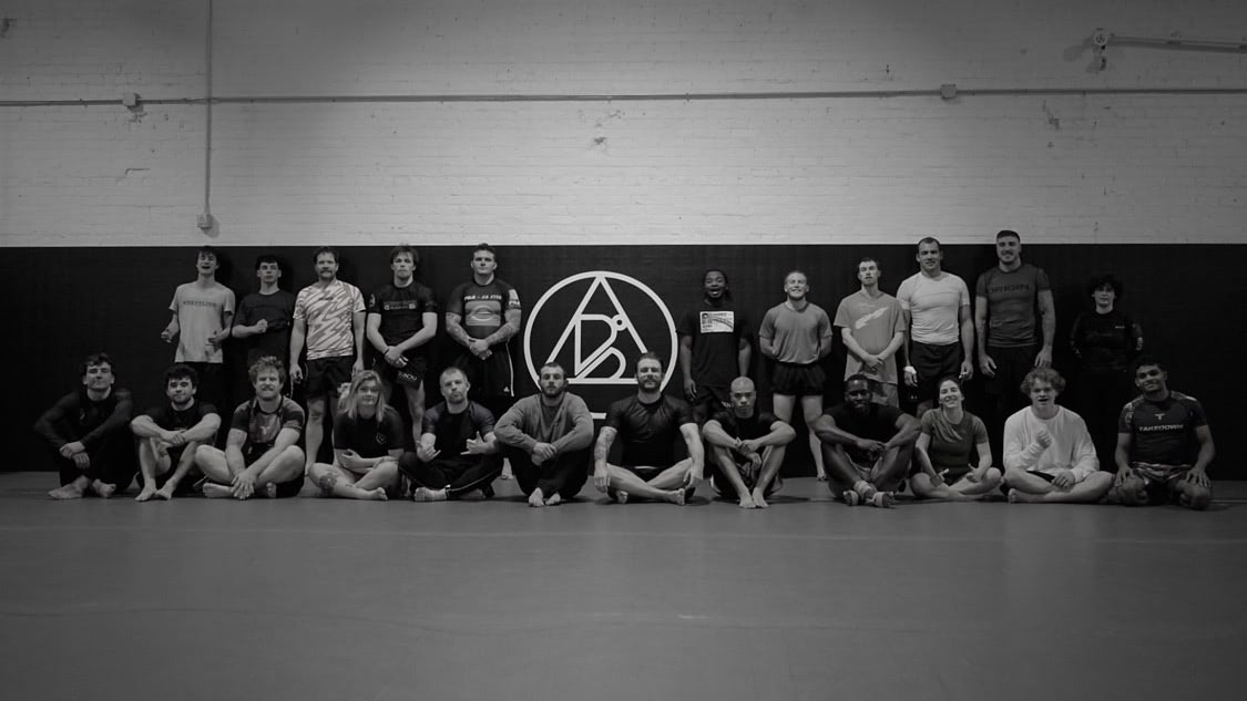 Blayne Hodges executing a guillotine during a live match,  owner and lead coach of Bendu Academy