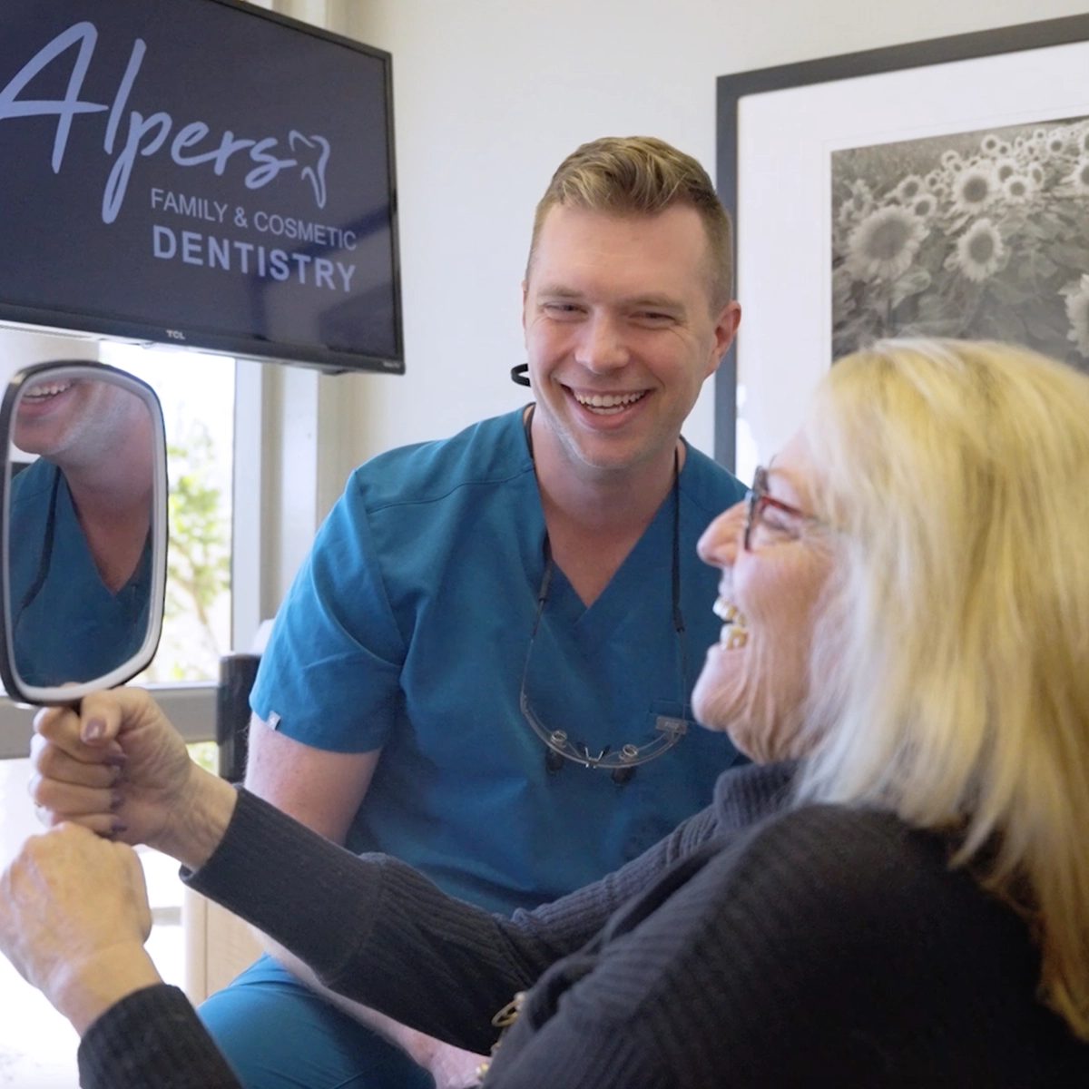 Dr. Alpers evaluating patient's smile at dental clinic in Scottsdale