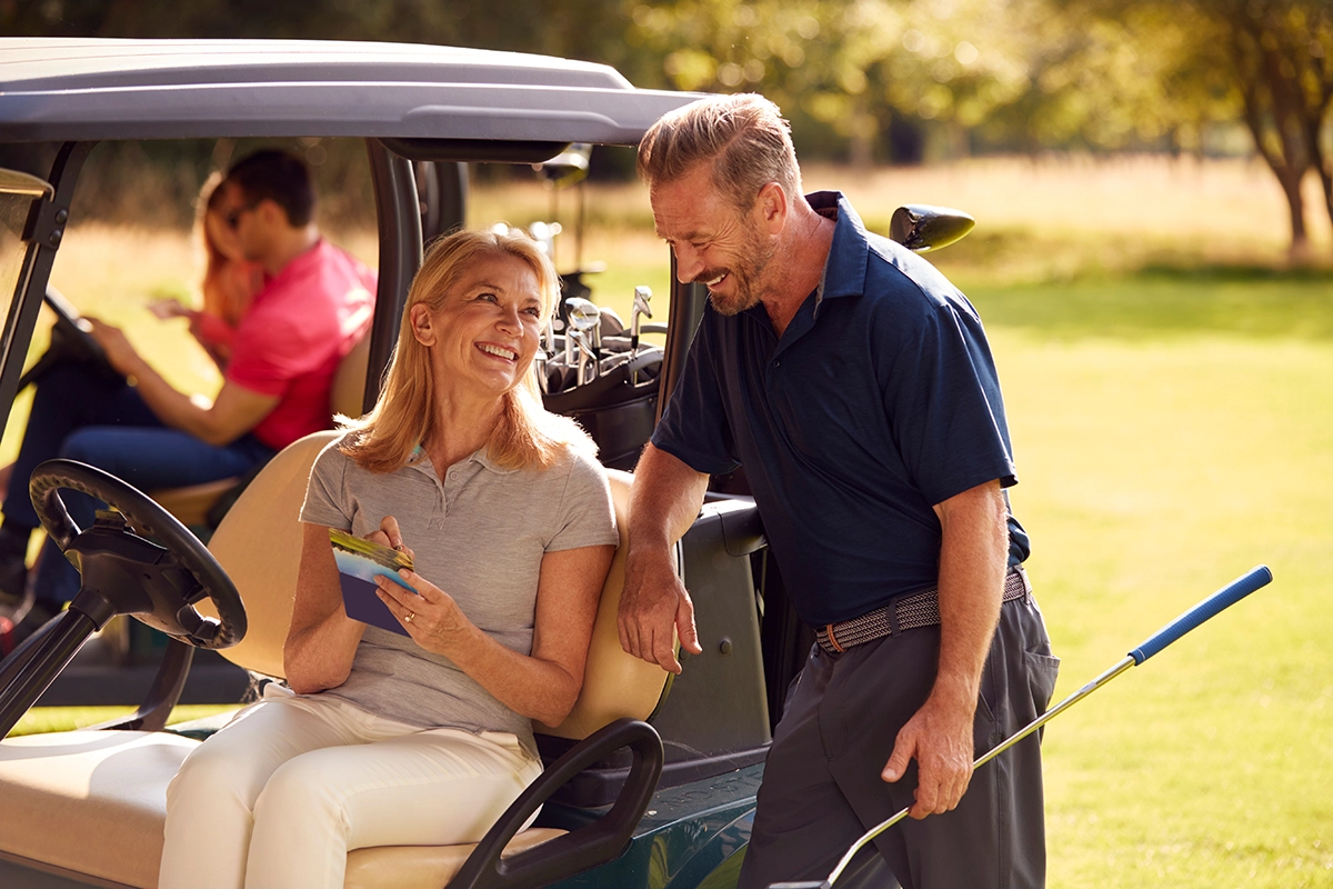 Couple golfing near Gainey Ranch, smiling and enjoying the golf course.