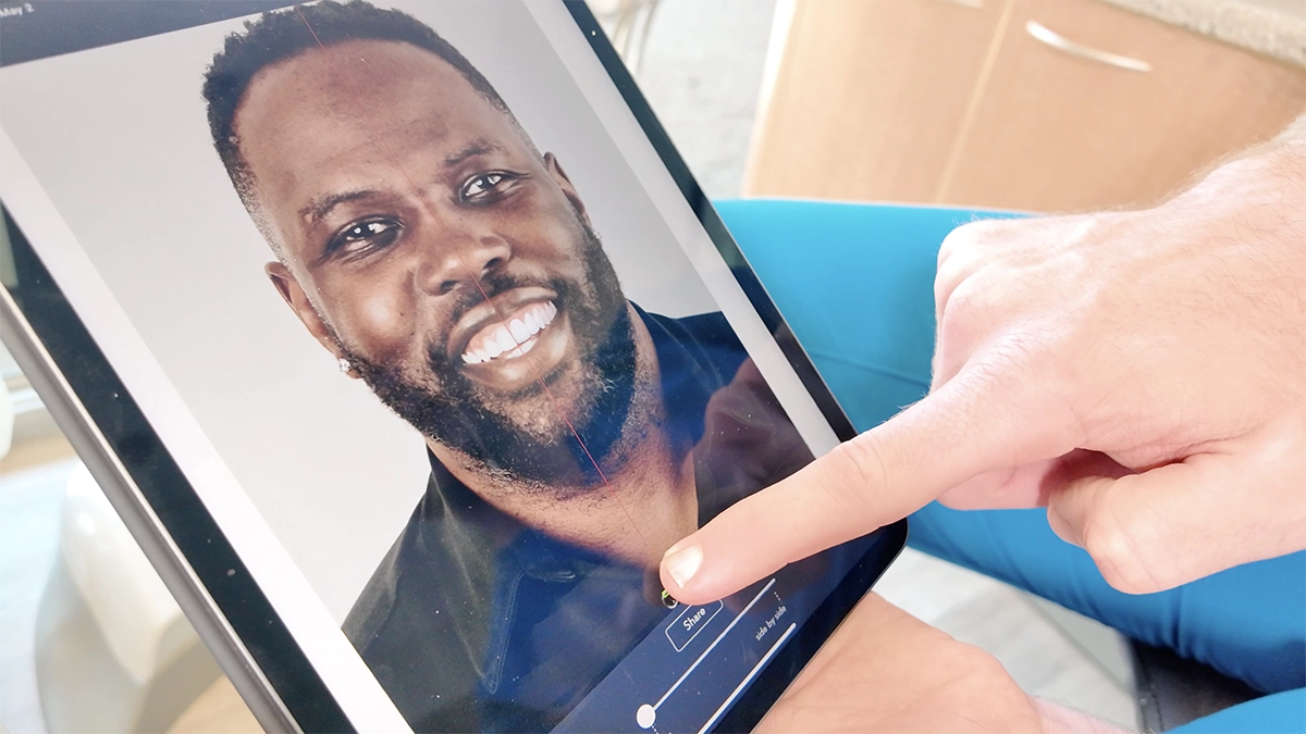 Dr. Alpers showing a patient their smile simulation on an iPad in the Scottsdale dental office