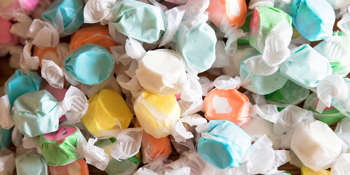 Colorful individually wrapped taffy candies, one of the worst Halloween candy choices for your teeth because they can stick to enamel.