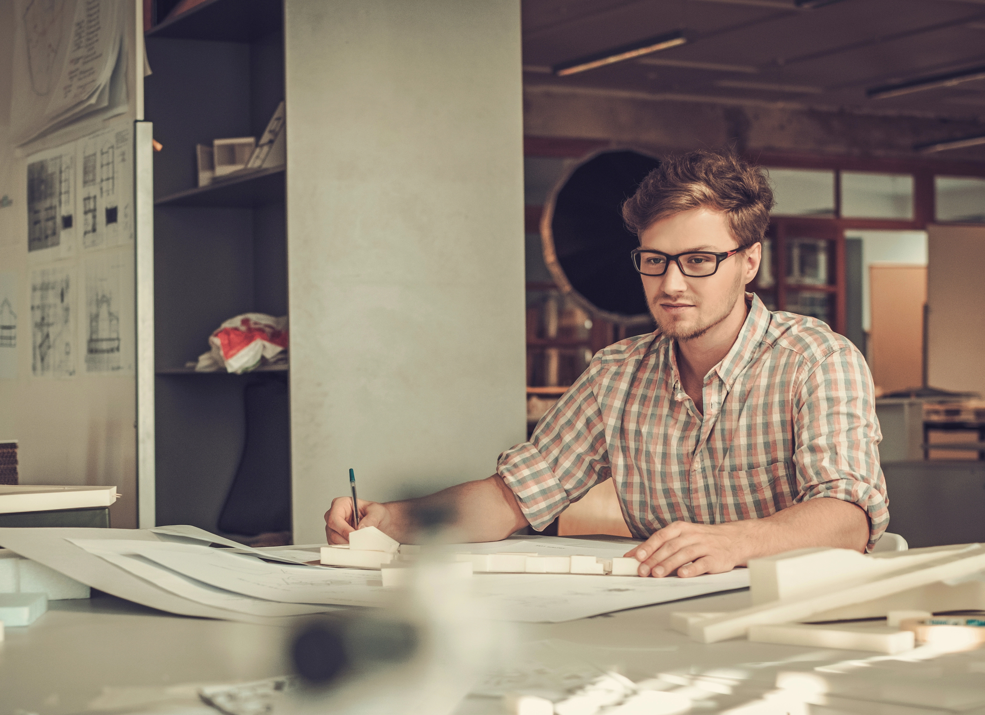 A man works on documents at a desk