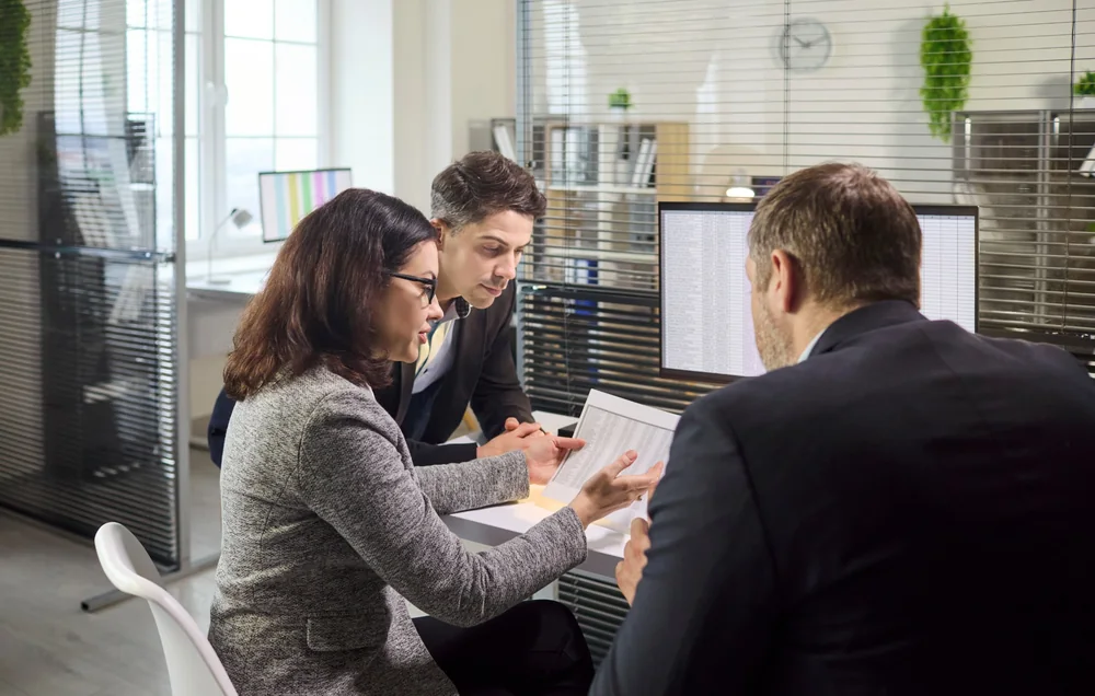 Business analysts reviewing plans and information together