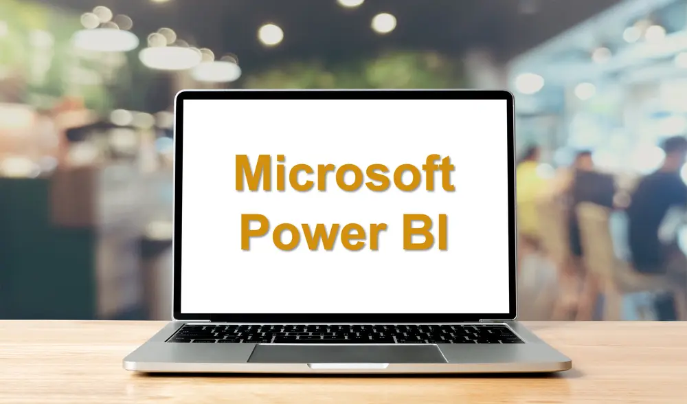 Image of laptop displaying an image containing the words Microsoft Power BI